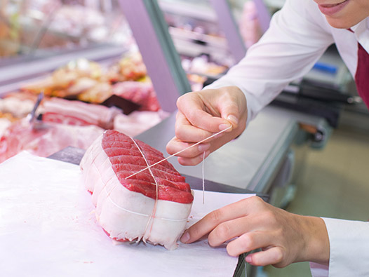 A butcher with a beef filet